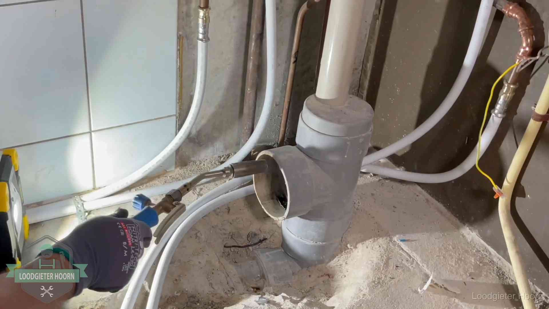 Loodgieter werkt aan leidingen bij de pvc-standleiding van een huurwoning in Hoorn