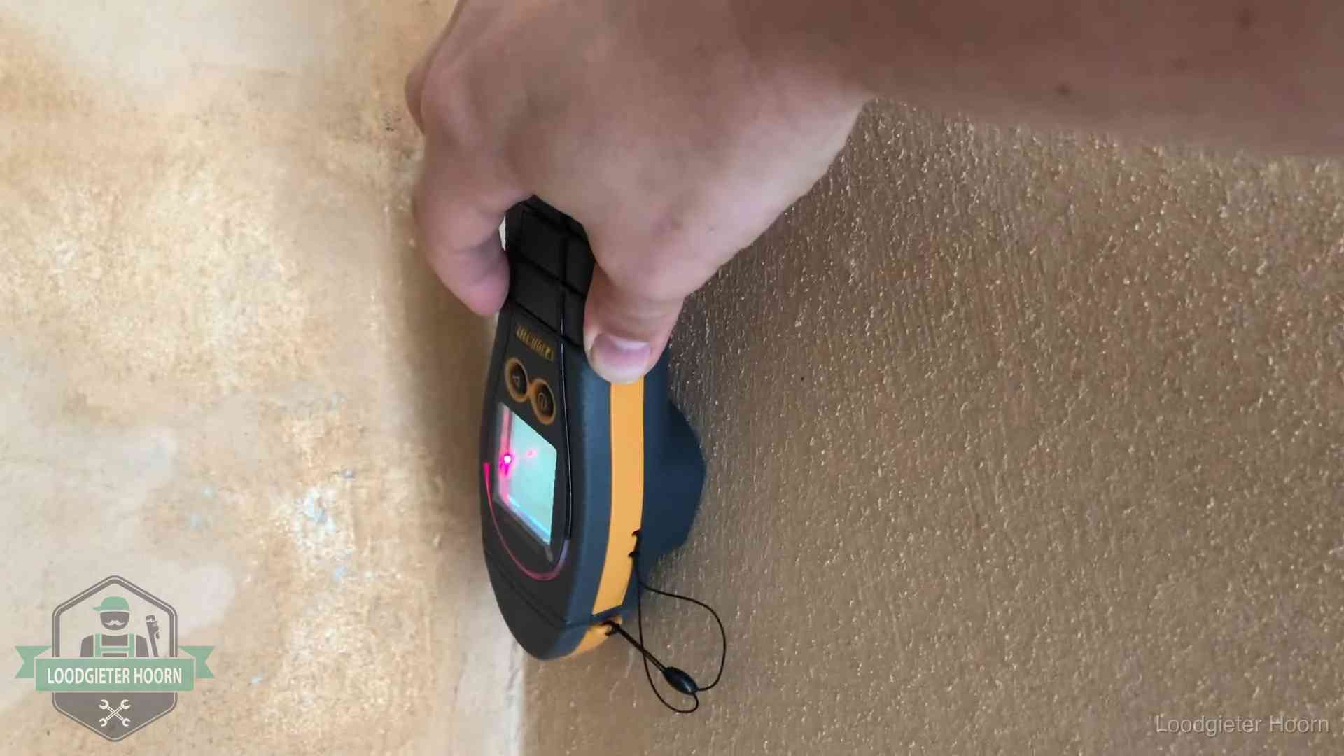 Daklekkage opsporen zonder hakwerk in Hoorn Vochtmeter tegen een muur met vochtplekken tijdens het opsporen van een daklekkage in Hoorn